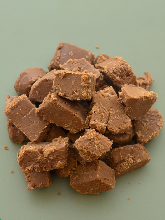Chunks of chocolate fudge on a green background