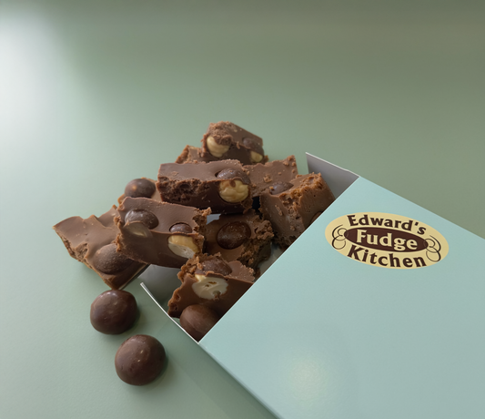 Chocolate fudge with maltesers in a box from Edward's Fudge Kitchen on a light green background