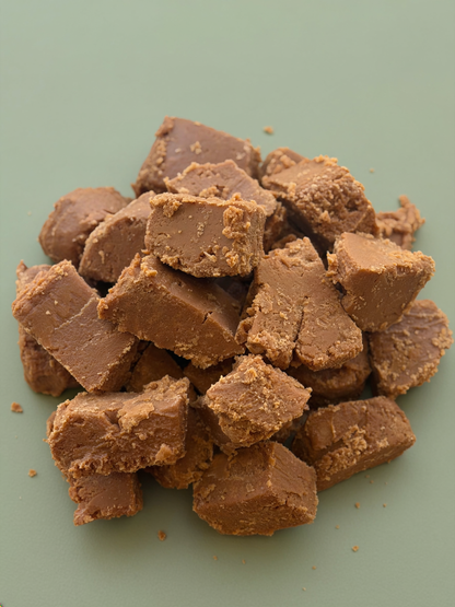 Chunks of chocolate fudge on a green background