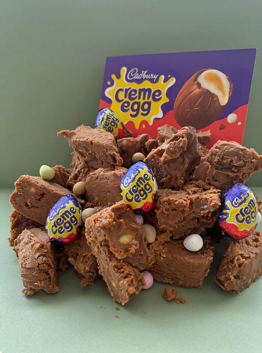 Fudge squares with Cadbury Creme Egg candies on a green background