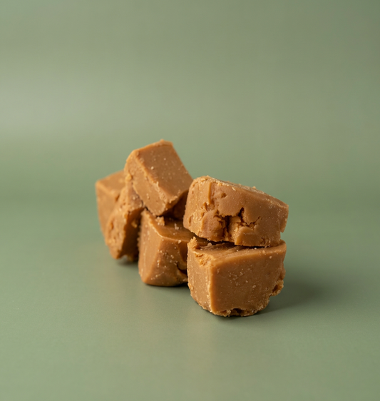 Stack of butterscotch fudge for gifting on a green background
