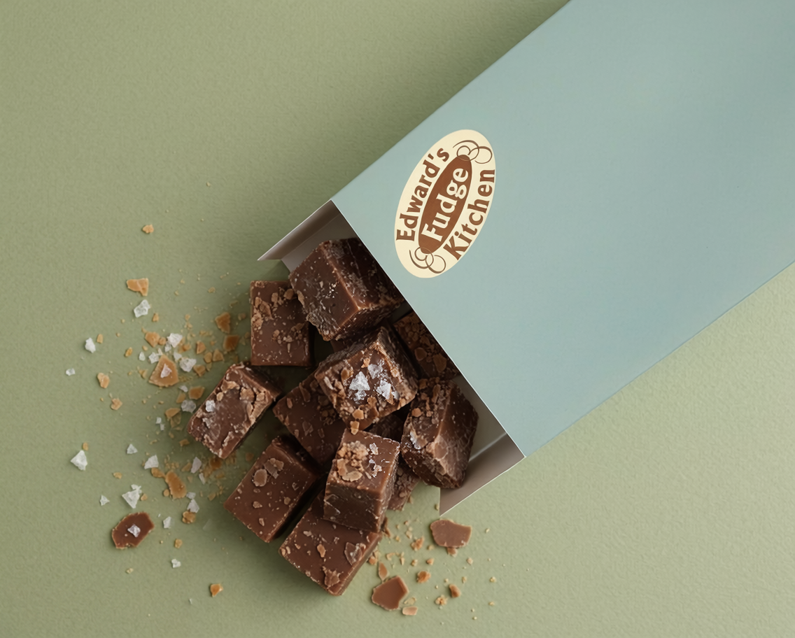 Box of chocolate fudge with a visible brand logo on a two-tone background