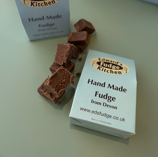 Handmade fudge with a box labeled 'Edward's Fudge Kitchen' on a light surface.
