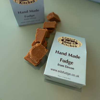 Handmade fudge pieces with 'Edward's Kitchen' packaging on a light surface